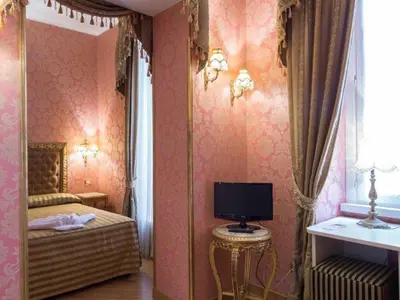 a bedroom with a bed and a tv on a wall at DCBoutiqueHotel in Rome