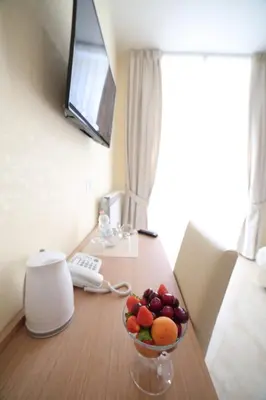a bowl of fruit on a desk in a hotel room at Esposizione Palace Hotel in Rome