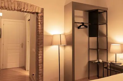 a mirror in a room with a lamp and a light at TrastevereInn in Rome