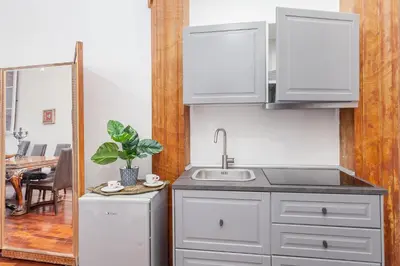 a kitchen with white cabinets and a sink at Palazzo Del Duca Piazza Navona Campo dei Fiori Piazza del Fico Guest House in Rome