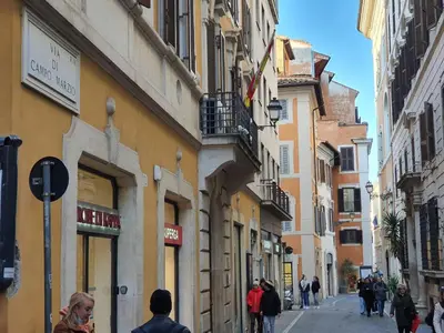 a group of people walking down a street with buildings at Campo Marzio Exclusive Maison in Rome