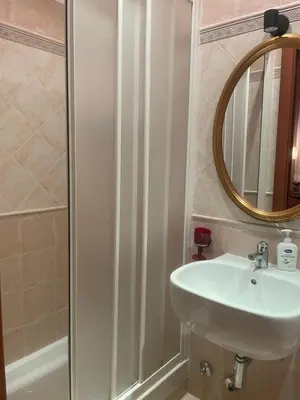 a bathroom with a shower and a toilet and a sink at Bye Rome Guesthouse in Rome