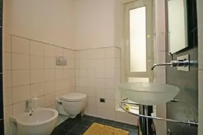 a bathroom with a toilet and a sink at Happy House Rienzo in Rome
