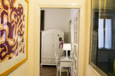 a hallway with a room with a table and a mirror at B&B Domus Piazza del Popolo in Rome