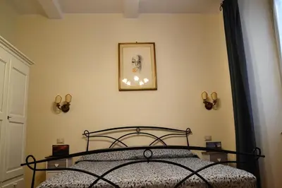a bedroom with a bed and a picture on the wall at B&B Domus Piazza del Popolo in Rome