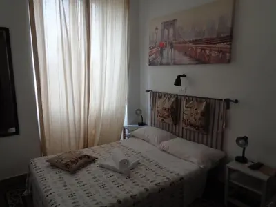 a bedroom with a bed with two books on it at T C RMs in Rome