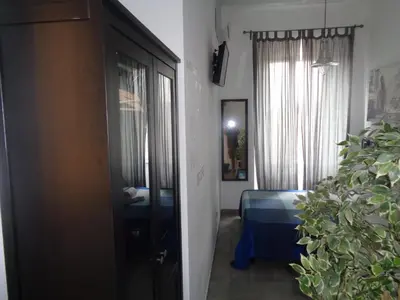 a room with a bedroom with a bed and a window at T C RMs in Rome