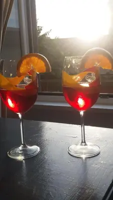 two wine glasses sitting on top of a table at T C RMs in Rome