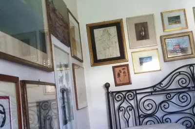 a wall with a bunch of pictures on it at Priscilla's inn in Rome