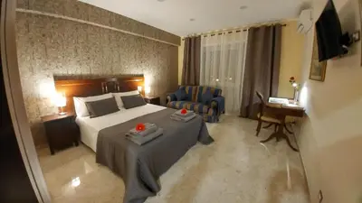 a hotel room with a bed and a chair at Vatican69 New Apartment in Rome