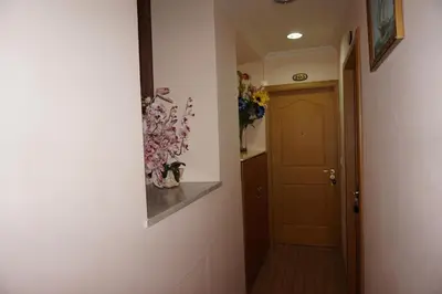 a hallway with a door and a vase of flowers at Hotel Filippo in Rome