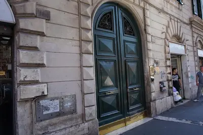 a green door on the side of a building at Hotel Filippo in Rome