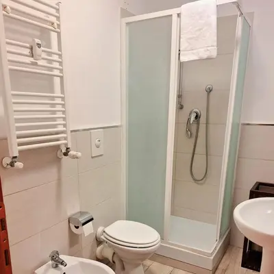 a bathroom with a shower and a toilet and a sink at St. Anthony Guest House in Rome