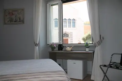 a bedroom with a bed and a window at St. Anthony Guest House in Rome