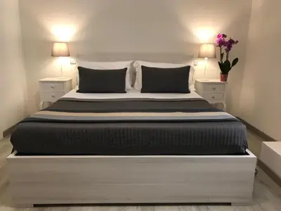 a bedroom with a large bed with two night stands at Angolo di Roma Guest house in Rome