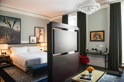 a hotel room with a bed and a chandelier at Hotel Vilòn - Small Luxury Hotels of the World in Rome
