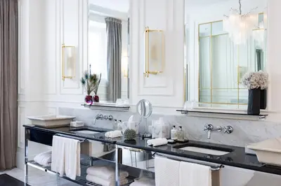 a bathroom with two sinks and two mirrors at Hotel Vilòn - Small Luxury Hotels of the World in Rome