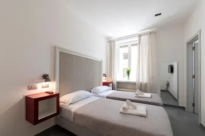 a bedroom with two beds and a window at Guest House Al Conservatorio in Rome