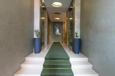 a hallway with stairs and plants in a building at Guest House Al Conservatorio in Rome