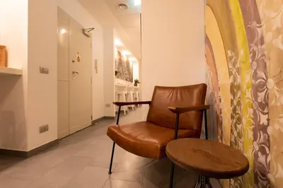 a room with a chair and a table at Guest House Al Conservatorio in Rome