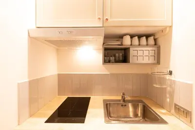 a kitchen with a sink and white cabinets at Guest House Al Conservatorio in Rome