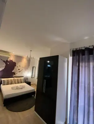 a bedroom with a bed and a black cabinet at Rome Sweet Home Vatican in Rome