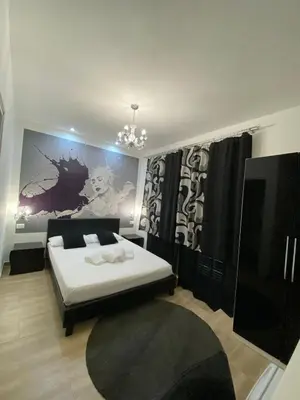 a bedroom with a bed and a flat screen tv at Rome Sweet Home Vatican in Rome