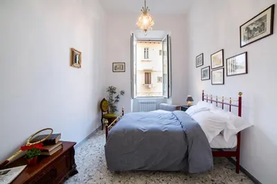 a bedroom with a bed and a window at Domus Aurea 295 in Rome