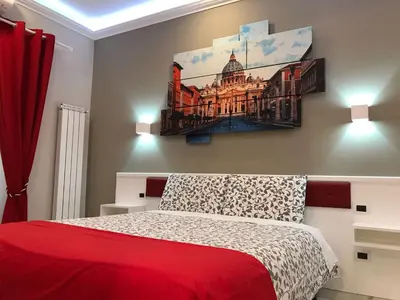a bedroom with a bed and a building on the wall at Ann Inn in Rome