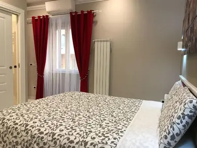 a bedroom with a bed and red curtains at Ann Inn in Rome