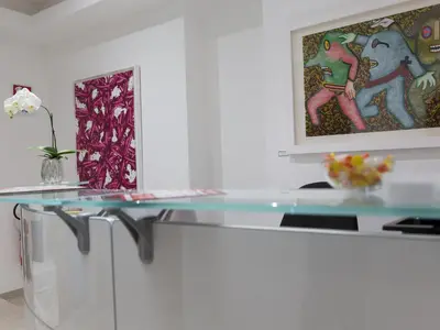 a glass table in a room with a painting at Venustas Roma Hotel in Rome