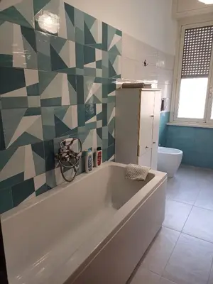a bathroom with a tub and a toilet at Double room da Giulio in Rome