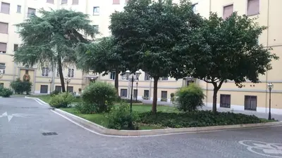 a building with trees in front of a street at Double room da Giulio in Rome