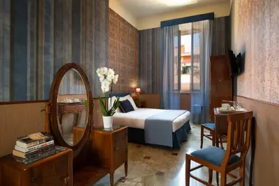 a bedroom with a bed and a mirror and a chair at Welcome House in Rome
