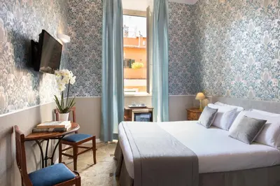 a bedroom with a bed and a table and a tv at Welcome House in Rome