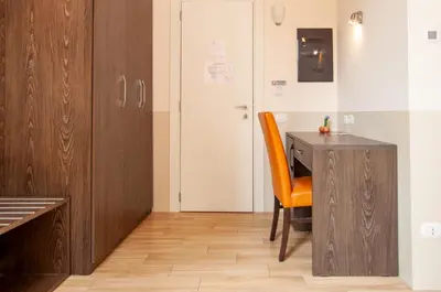 a room with a desk and a chair next to a door at Domus Porta Angelica in Rome