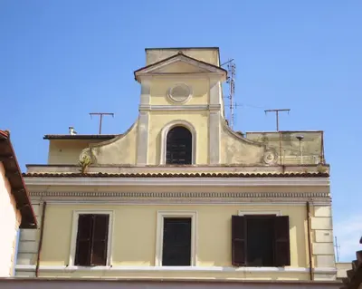a building with a clock tower on top of it at Le Volute al Pigneto in Rome