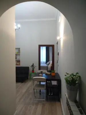 a living room with a table and a chair at Le Volute al Pigneto in Rome
