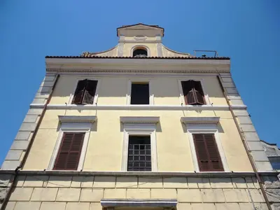 a tall building with a clock tower on top of it at Le Volute al Pigneto in Rome