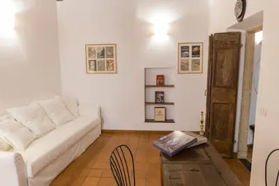 a living room with a white couch and a table at Behind Navona in Rome