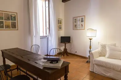 a living room with a table and a couch at Behind Navona in Rome
