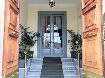 a blue door in a room with stairs at Palazzo Baj in Trastevere in Rome