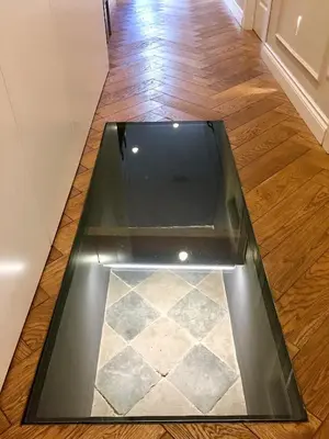a glass floor in a room with a tile floor at Palazzo Baj in Trastevere in Rome