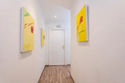 a hallway with paintings on the walls of a room at Aurelia Home Guest House in Rome
