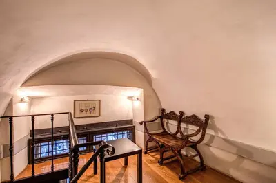 a room with a chair and a fireplace at Magenta Collection Specchi in Rome
