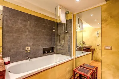 a bathroom with a bath tub and a shower at Magenta Collection Specchi in Rome