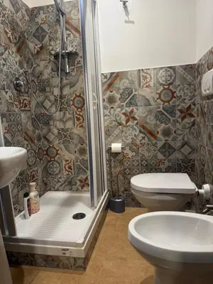 a bedroom with a bed and a desk with a mirror at Clarian Affittacamere in Rome