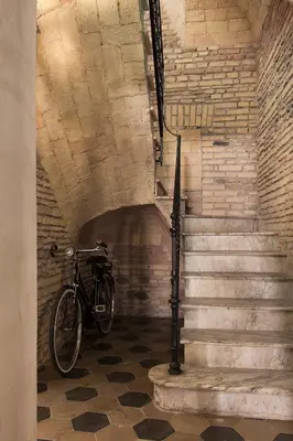 a bike parked next to a staircase in a building at Casa de' Coronari Suites in Rome