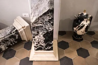 a bathroom with a black and white painting on the wall at Casa de' Coronari Suites in Rome