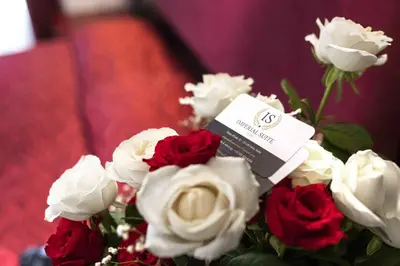 a bouquet of red and white roses in a vase at Imperial Suite Guest House in Rome